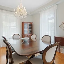 a dining room table with chairs and a china cabinet related to Elegant Window Treatments with Park Designs Valance
