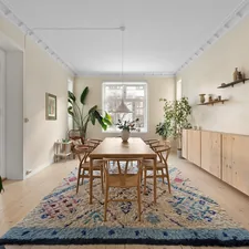 A dining room with a rug on the floor related to Niels Jonsson Sideboard: A Timeless Classic Reimagined