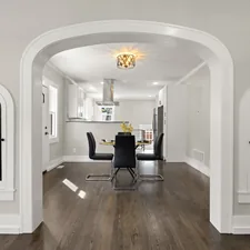 a dining room with a table and chairs in it related to Valances for Arched Windows: Enhancing Your Home's Aesthetic