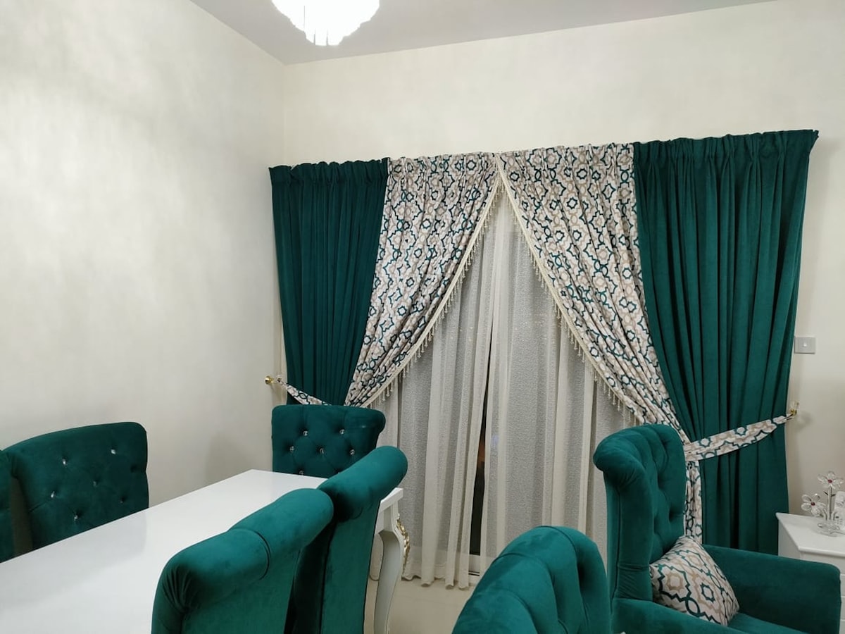 a dining room with green chairs and a white table related to Curtains and Valances Sets