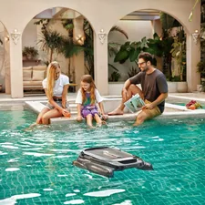 A family relaxing poolside as Aiper Surfer S1 pool skimmer glides through the water. related to Discover the Comfort and Convenience of the Peapod Plus Travel Bed