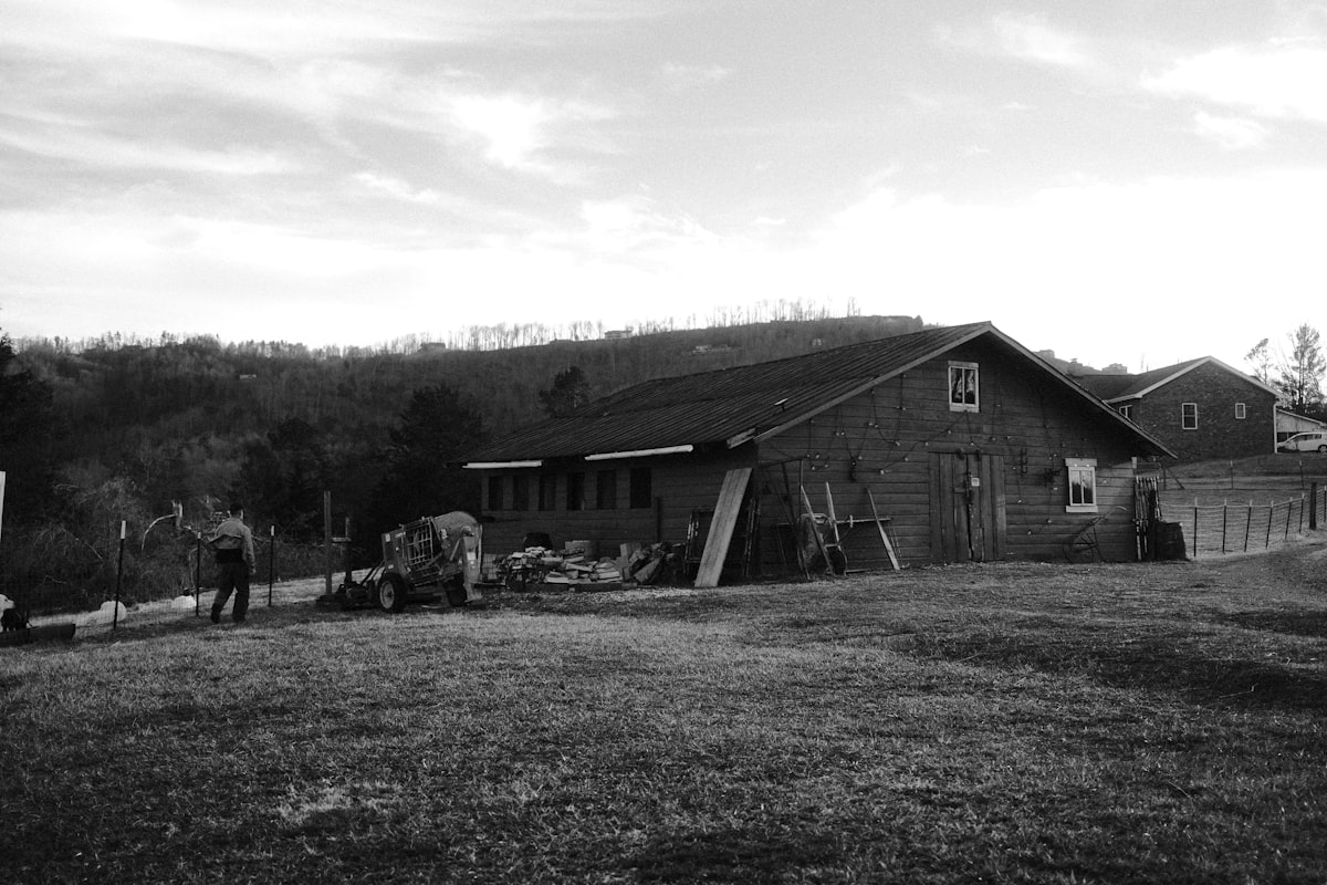 A farm barn stands on a grassy field. related to Bed and Breakfast Asheville