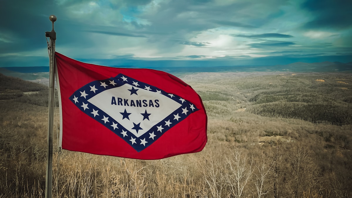 a flag in a field with a sky in the background related to Discover the Best Bed and Breakfasts in Arkansas