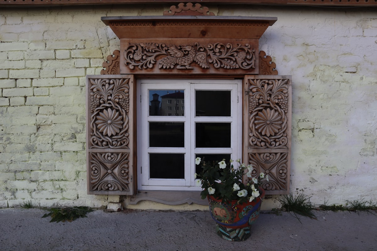 a flower pot sitting in front of a window related to Wood Window Valence Ideas