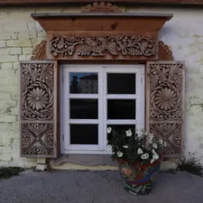 a flower pot sitting in front of a window related to Wood Window Valence Ideas