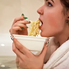 A girl eating instant noodles in a jacuzzi wearing a bathrobe related to Weighing Your Options: The Bed Bath & Beyond Food Scale