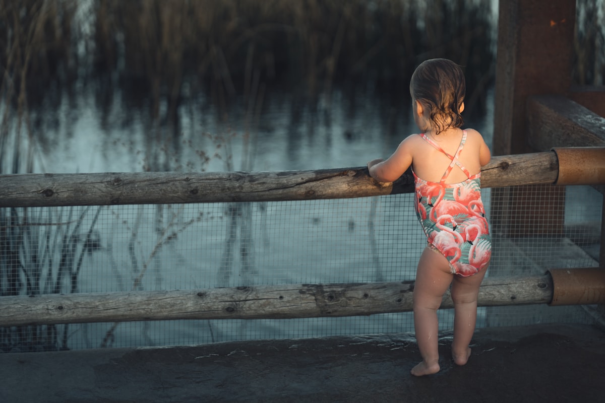 a girl standing on a bridge related to Essential Guide to Choosing the Best Rail for Toddler Bed