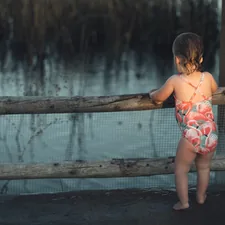 a girl standing on a bridge related to Essential Guide to Choosing the Best Rail for Toddler Bed