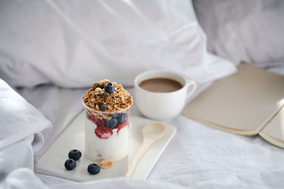 a glass of yogurt and a cup of coffee on a tray related to Fueling Sleep: The Power of Oatmeal Before Bed