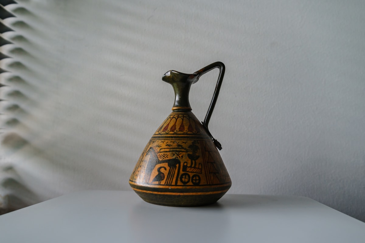 a glass teapot on a table related to The Warmth of the Past: Uncovering the Charm of Antique Bed Warmers