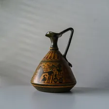 a glass teapot on a table related to The Warmth of the Past: Uncovering the Charm of Antique Bed Warmers