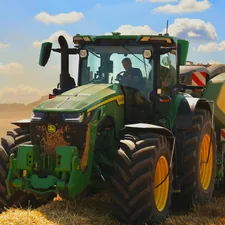 A green tractor with a baler working in a field. related to Transform Your Child's Room with a Tractor Bedding Set