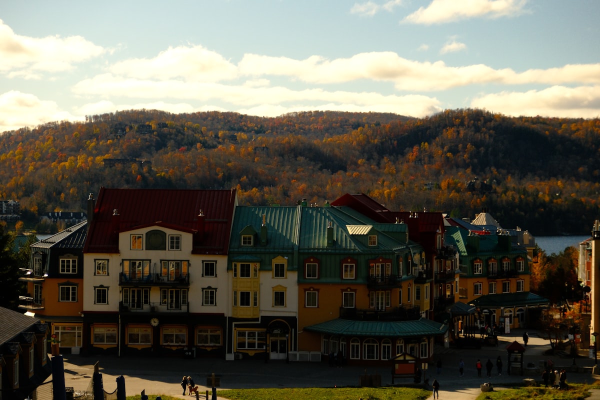 a group of buildings with a mountain in the background related to Charming Stays in Quebec City