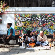 a group of people sitting on the ground in front of a wall related to Transform Your Space with a Lori Wall Bed
