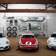 a group of three cars parked next to each other related to Rev Up Your Child's Bedroom with Exciting Race Car Beds for Sale