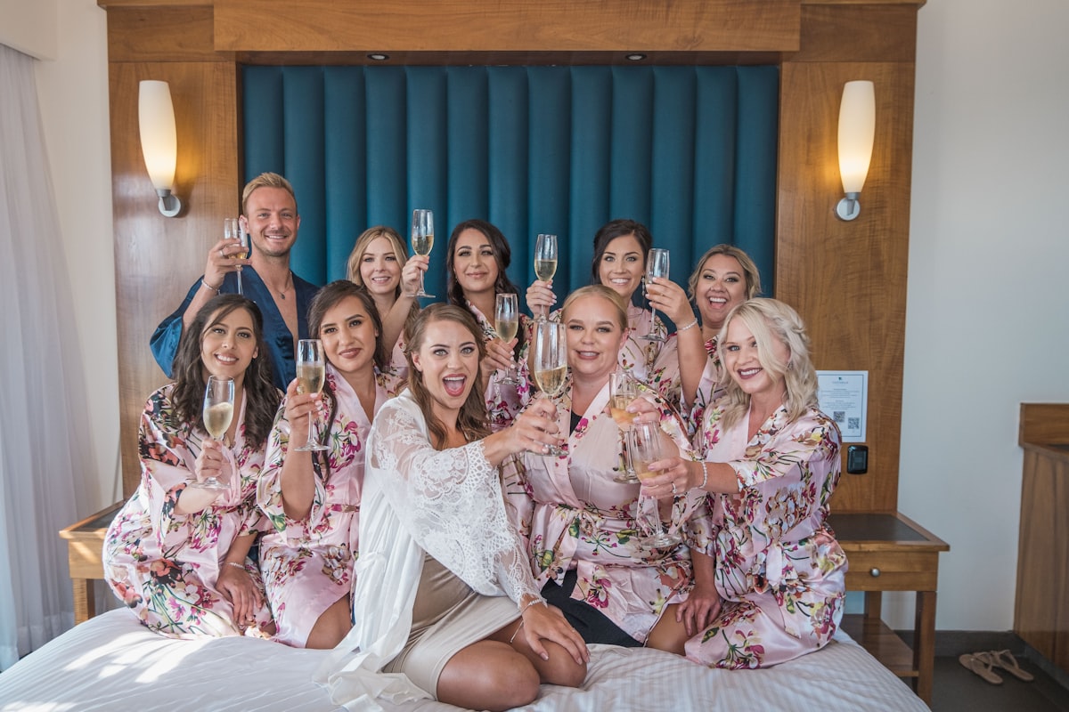 a group of women sitting on top of a bed related to Start Your Life Together: A Guide to Bed Bath & Beyond Wedding Registry