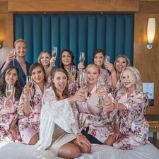 a group of women sitting on top of a bed related to Start Your Life Together: A Guide to Bed Bath & Beyond Wedding Registry