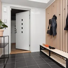 A hallway with a bench and coat rack related to Elevate Your Entryway: The Benefits of Modular Furniture