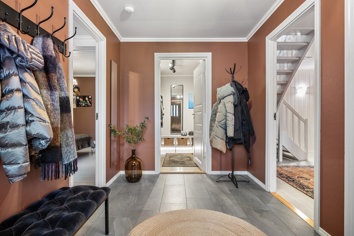 A hallway with a coat rack and a bench related to Unlocking Potential:  Entryway Closet Design