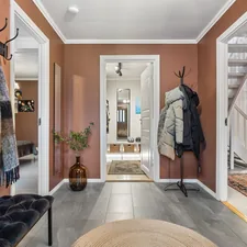 A hallway with a coat rack and a bench related to Unlocking Potential:  Entryway Closet Design