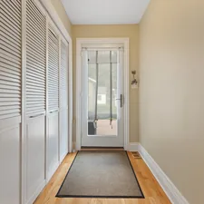 a hallway with a door and a rug on the floor related to Maximizing Space in Your Home with Entryway Storage Cabinets