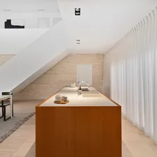 A kitchen and dining room with a staircase in the background related to Kitchen Curtain Valances: Elevate Your Kitchen Decor