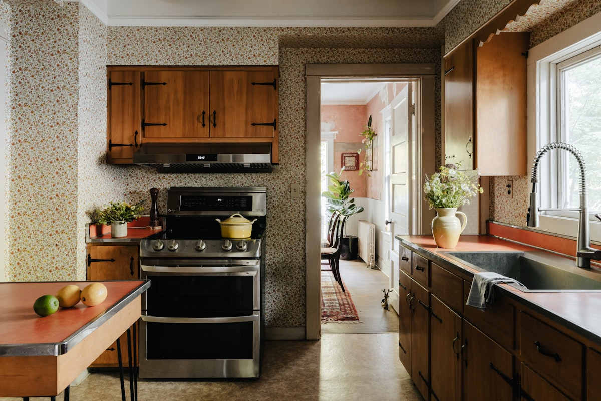 A kitchen with a stove, sink, and refrigerator related to Timeless Elegance: A Guide to Retro Kitchen Curtains and Valances