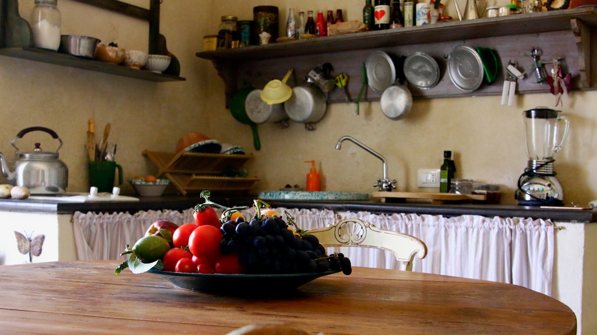 a kitchen with a table and a sink with food on it related to French Country Kitchen Valances: Elegance and Charm for Your Space