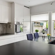 A kitchen with a table and chairs next to a window related to Black Kitchen Curtains and Valances
