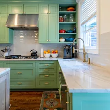 a kitchen with green cabinets and marble counter tops related to Elevate Your Kitchen Design with Black Kitchen Valances