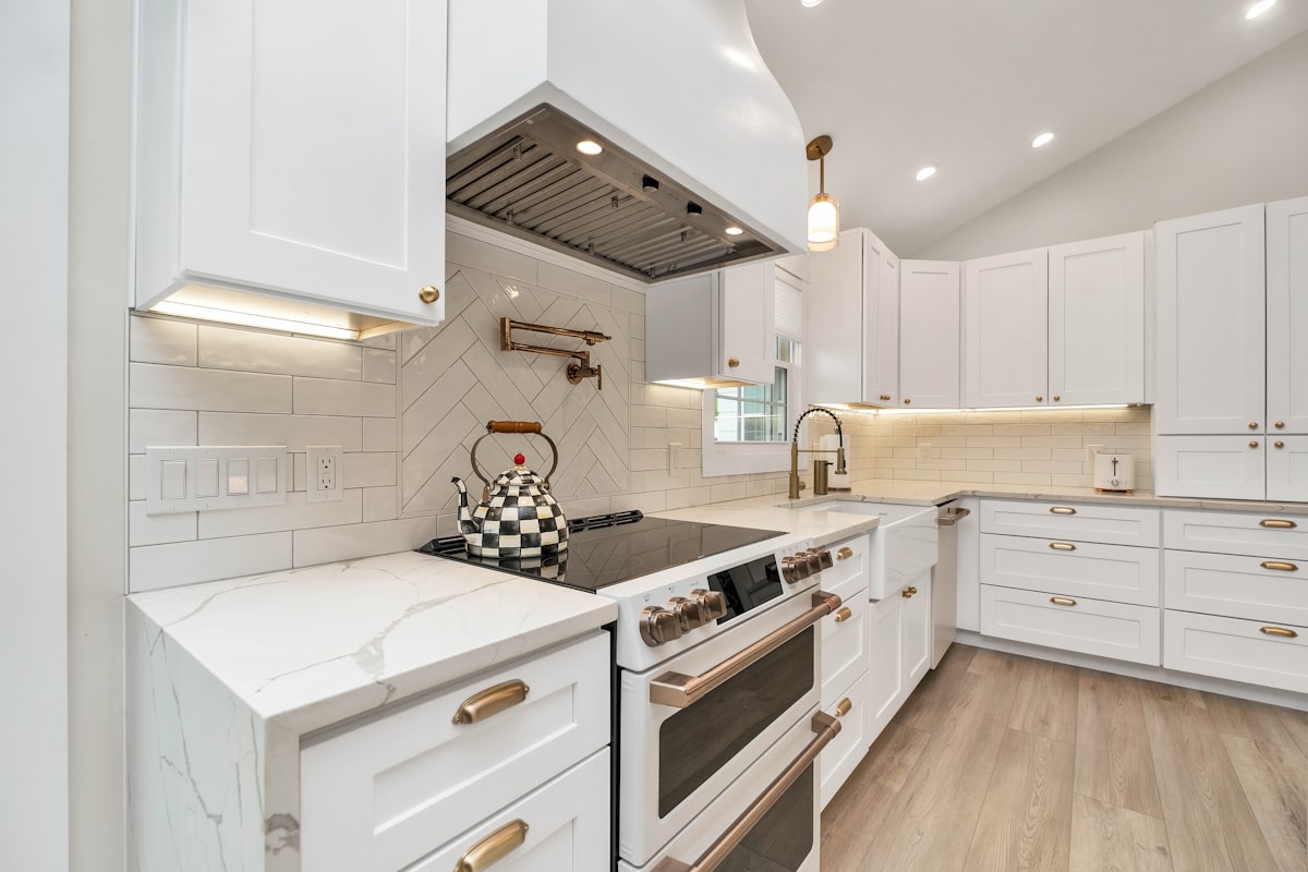 a kitchen with white cabinets and a stove top oven related to Elevate Your Kitchen with Custom Valances