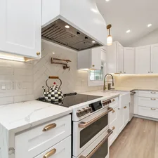 a kitchen with white cabinets and a stove top oven related to Elevate Your Kitchen with Custom Valances