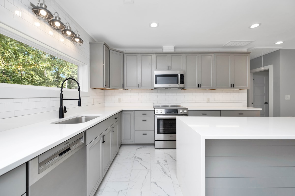 a kitchen with white cabinets related to Elevating Kitchen Style: The Beauty of Valances for Bay Windows