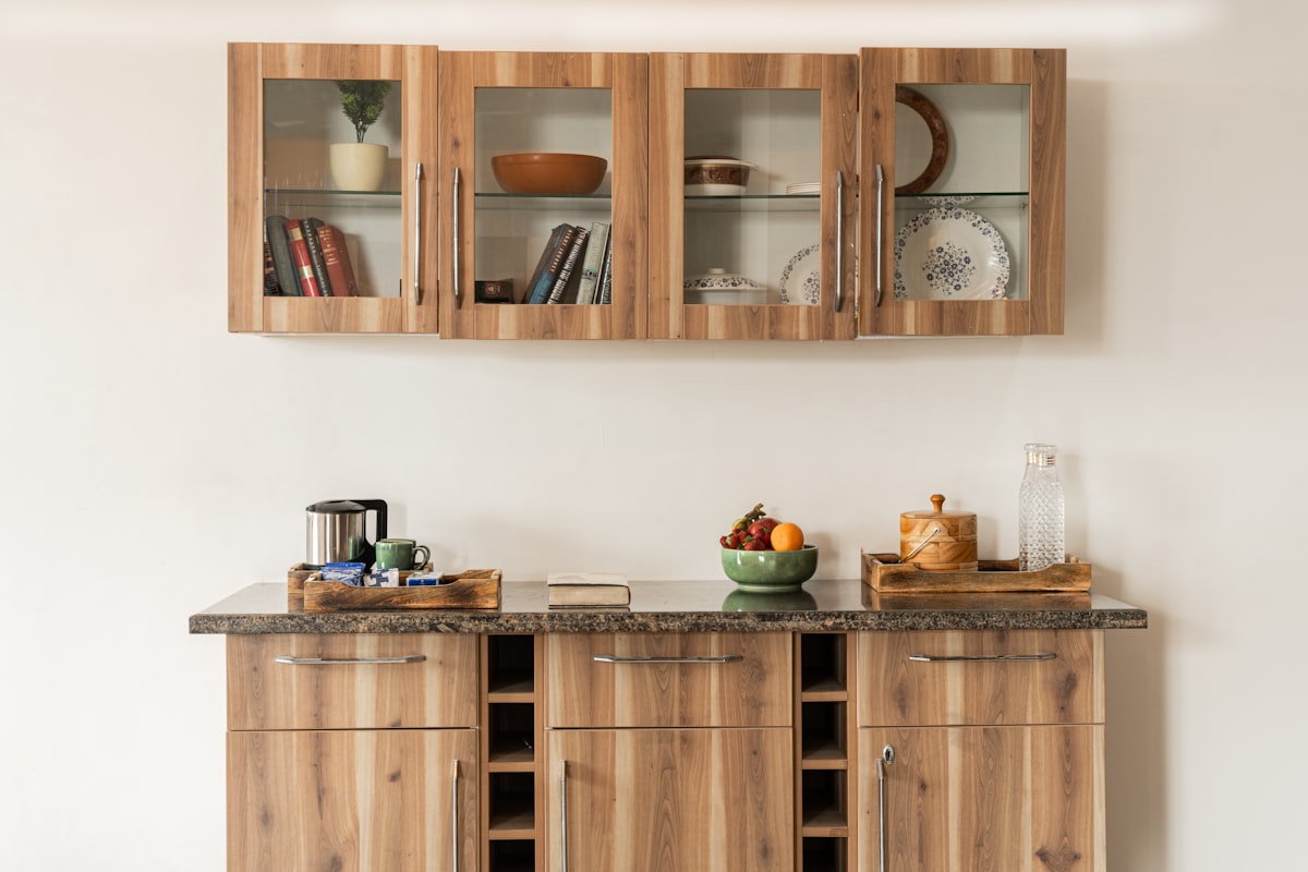 a kitchen with wooden cabinets and a bowl of fruit related to Enhance Your Home Decor with a Sideboard with Glass Doors