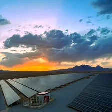 a large array of solar panels in a desert related to Brighten Up Your Bedroom with Solar System Bedding
