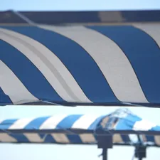 a large blue and white striped umbrella on a sunny day related to Striped Valances for Windows: Elegance and Style Redefined