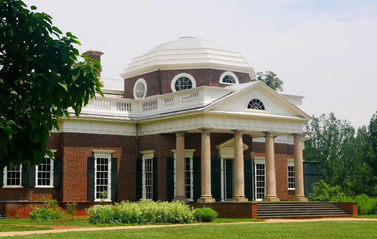 A large brick house with white columns and dome. related to Discover Charming Bed and Breakfasts in Jefferson, TX