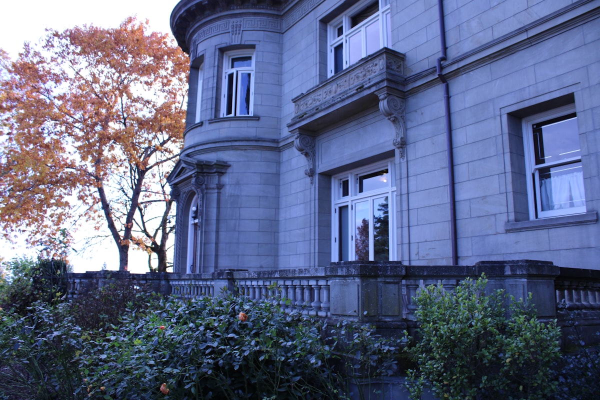 a large gray building with a clock on the front of it related to A Cozy Getaway in Portland: Top Bed and Breakfast Options