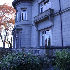 a large gray building with a clock on the front of it related to A Cozy Getaway in Portland: Top Bed and Breakfast Options