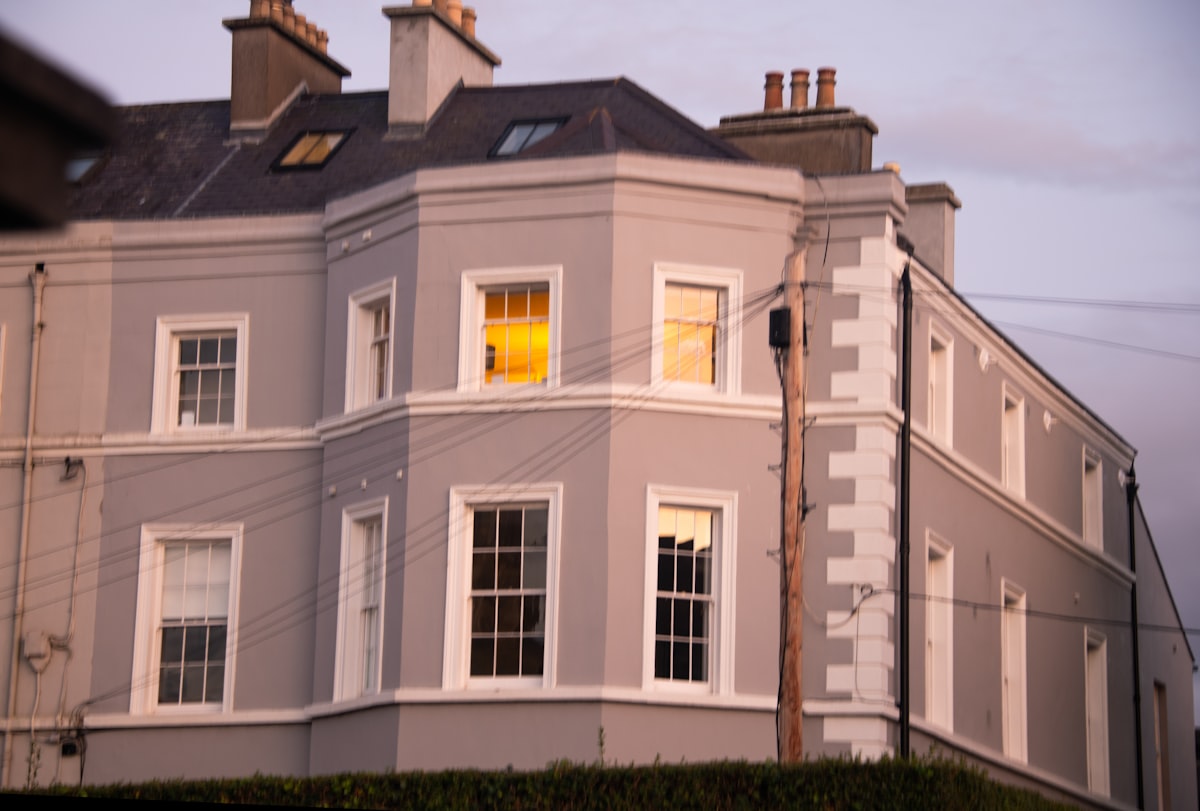 A large gray building with white trim and windows. related to Bay Window Valances: Elevating Your Home's Style