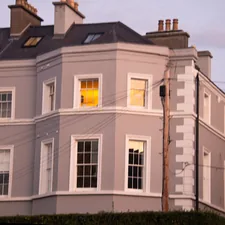 A large gray building with white trim and windows. related to Bay Window Valances: Elevating Your Home's Style