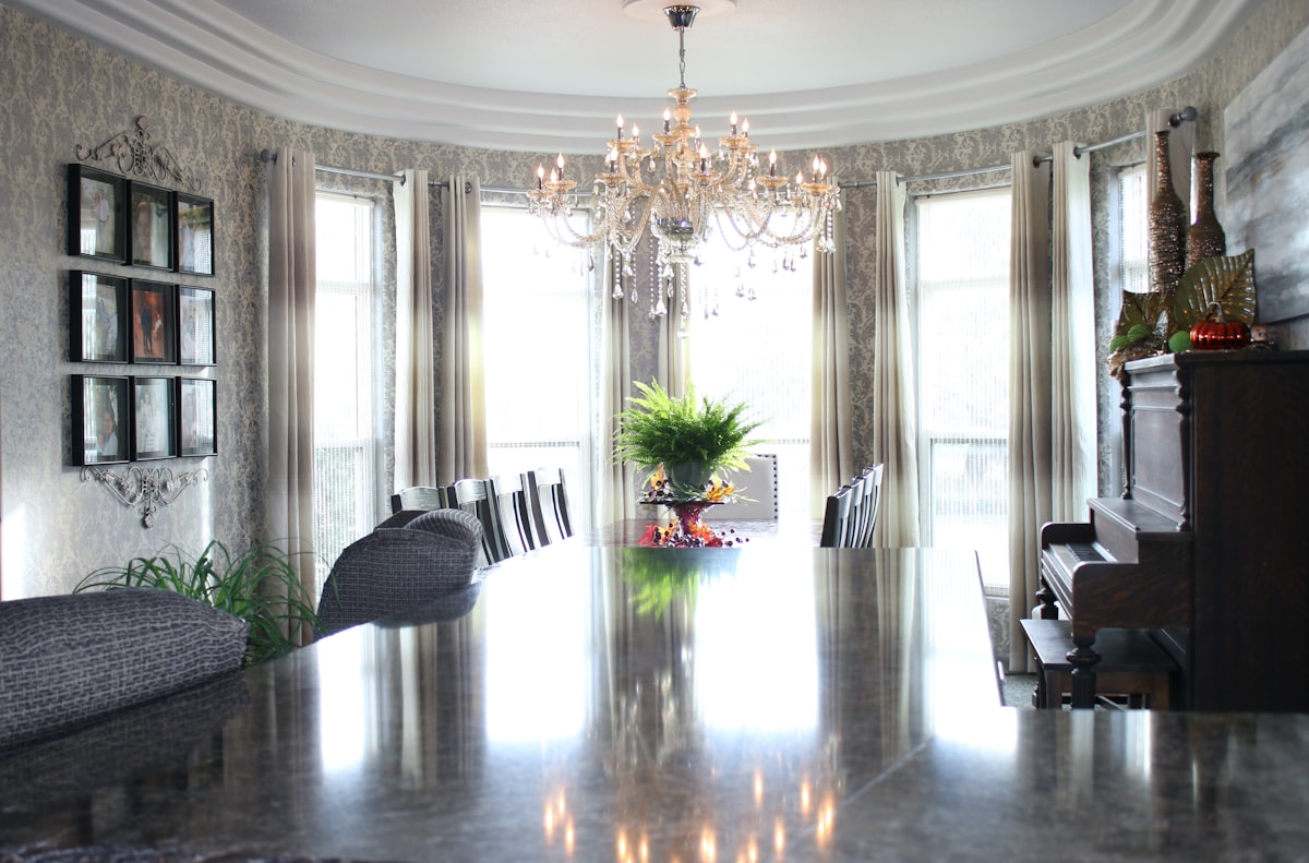 a large room with a piano and chandelier related to Elegant Window Treatments with Park Designs Valance