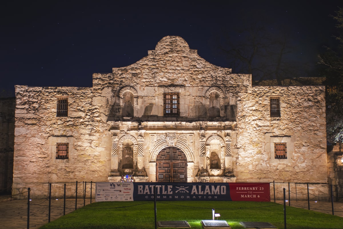 a large stone building with a sign in front of it related to Experience the Charm of San Antonio Bed and Breakfast