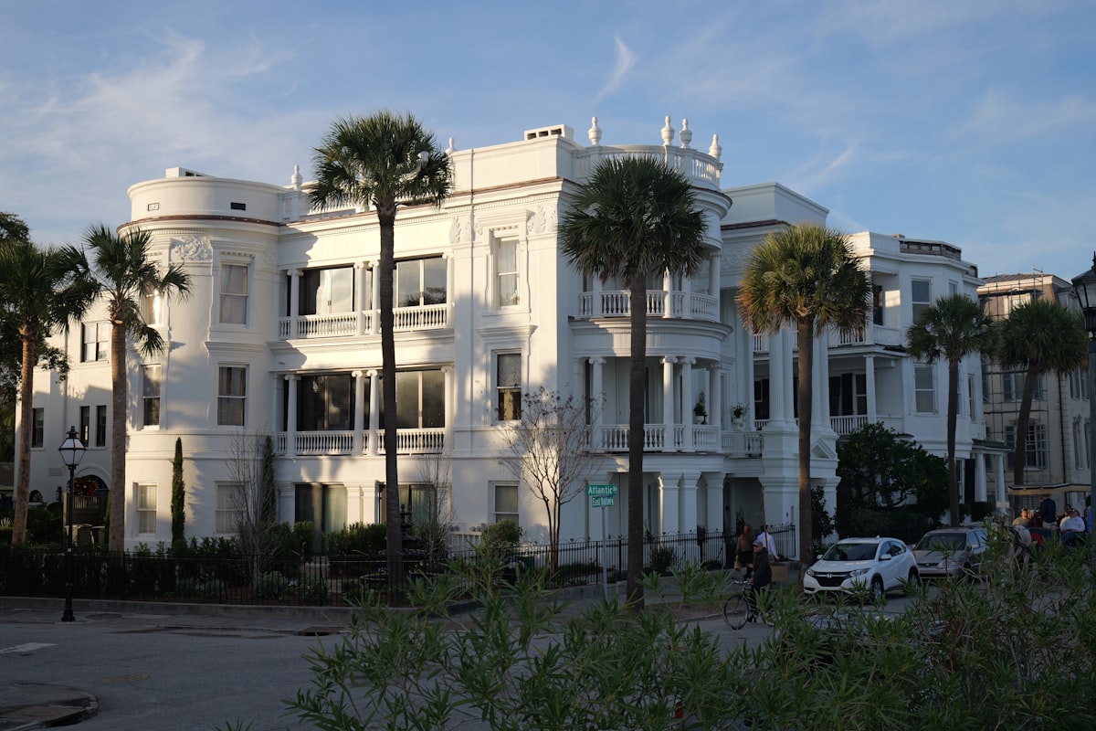 A large white building with palm trees in front of it related to Exploring Bed Bath and Beyond in Charleston