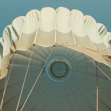 a large white umbrella with a blue sky in the background related to Balloon Shade Valance: Elevate Your Window Style