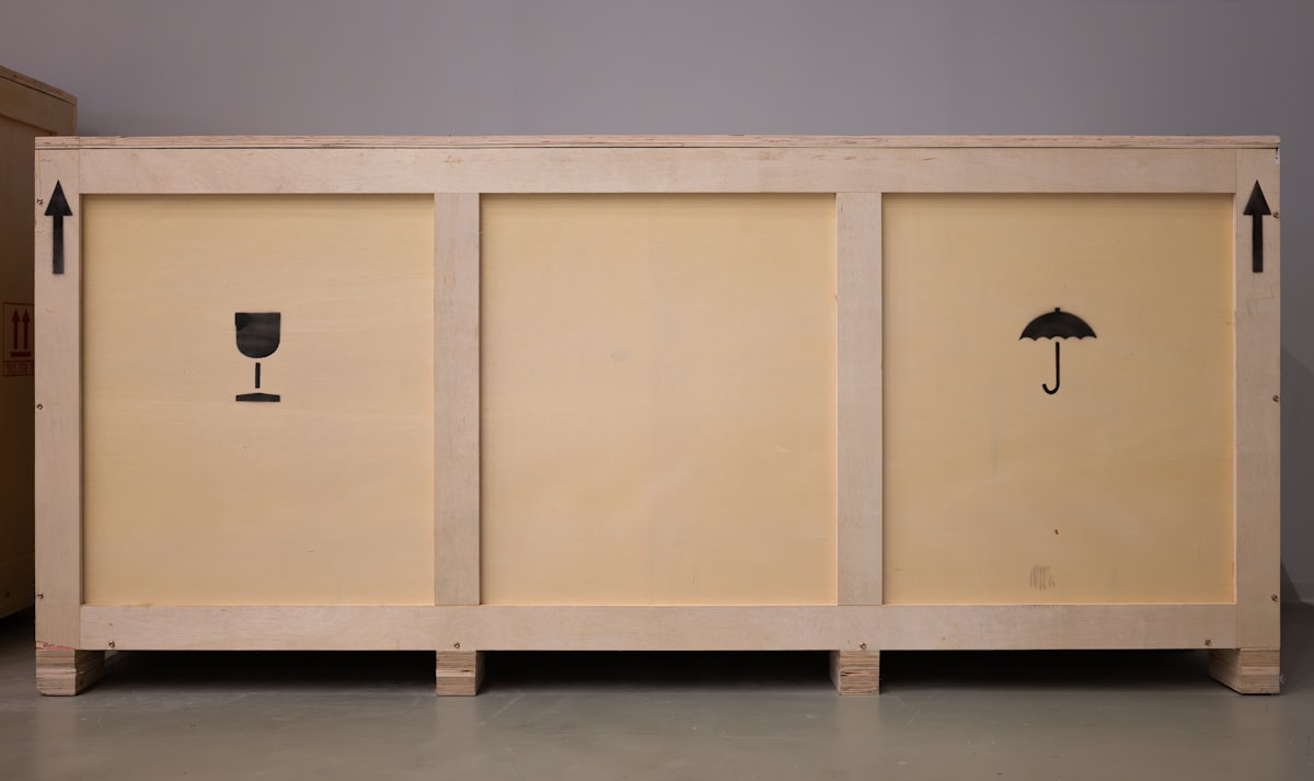 A large wooden crate with shipping symbols. related to The Ultimate Guide to Incorporating a 72 Inch Sideboard in Your Home