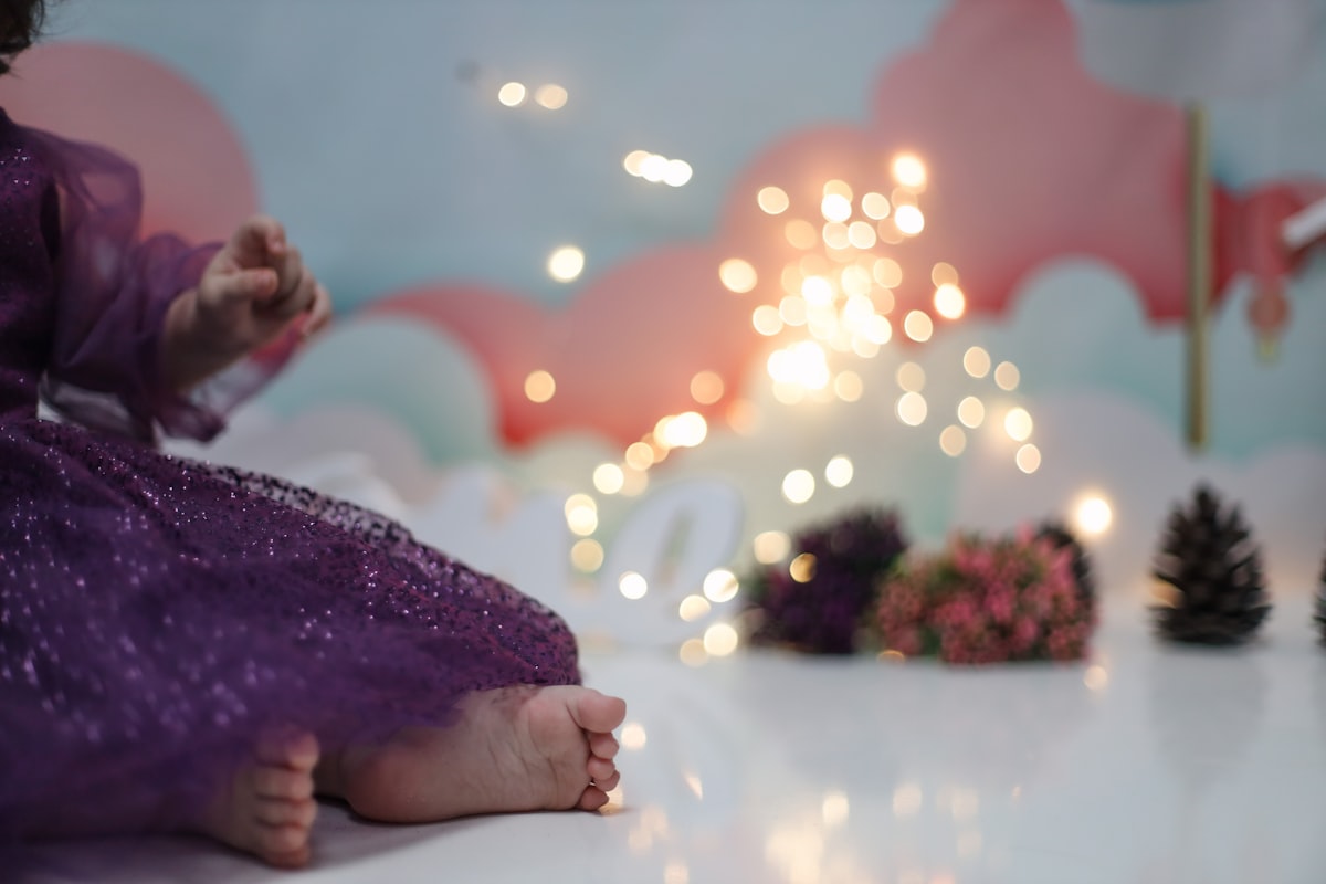 a little girl in a purple dress sitting on a table related to Magical Dreams Await with a Toddler Bed Mickey Mouse