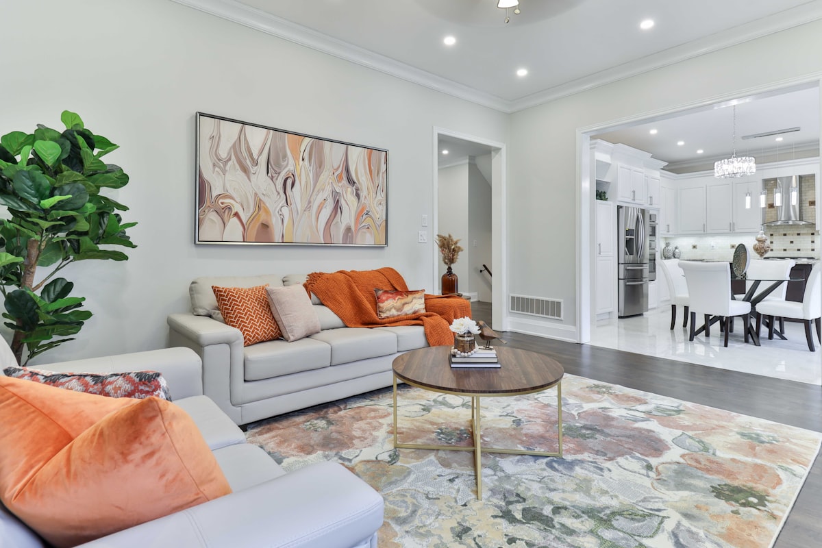 a living room filled with furniture and a painting on the wall related to Burnt Orange Coverlet: Elevate Your Home Decor