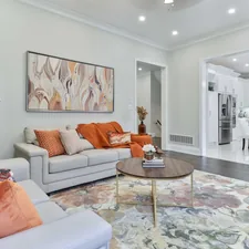 a living room filled with furniture and a painting on the wall related to Burnt Orange Coverlet: Elevate Your Home Decor