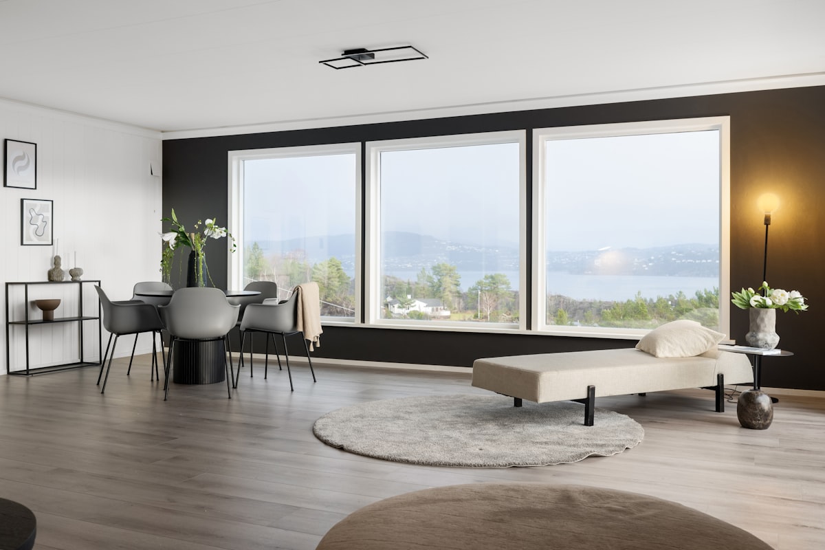 A living room with a couch a chair and a large window related to Elevate Your Windows with Stylish Valances for Sale